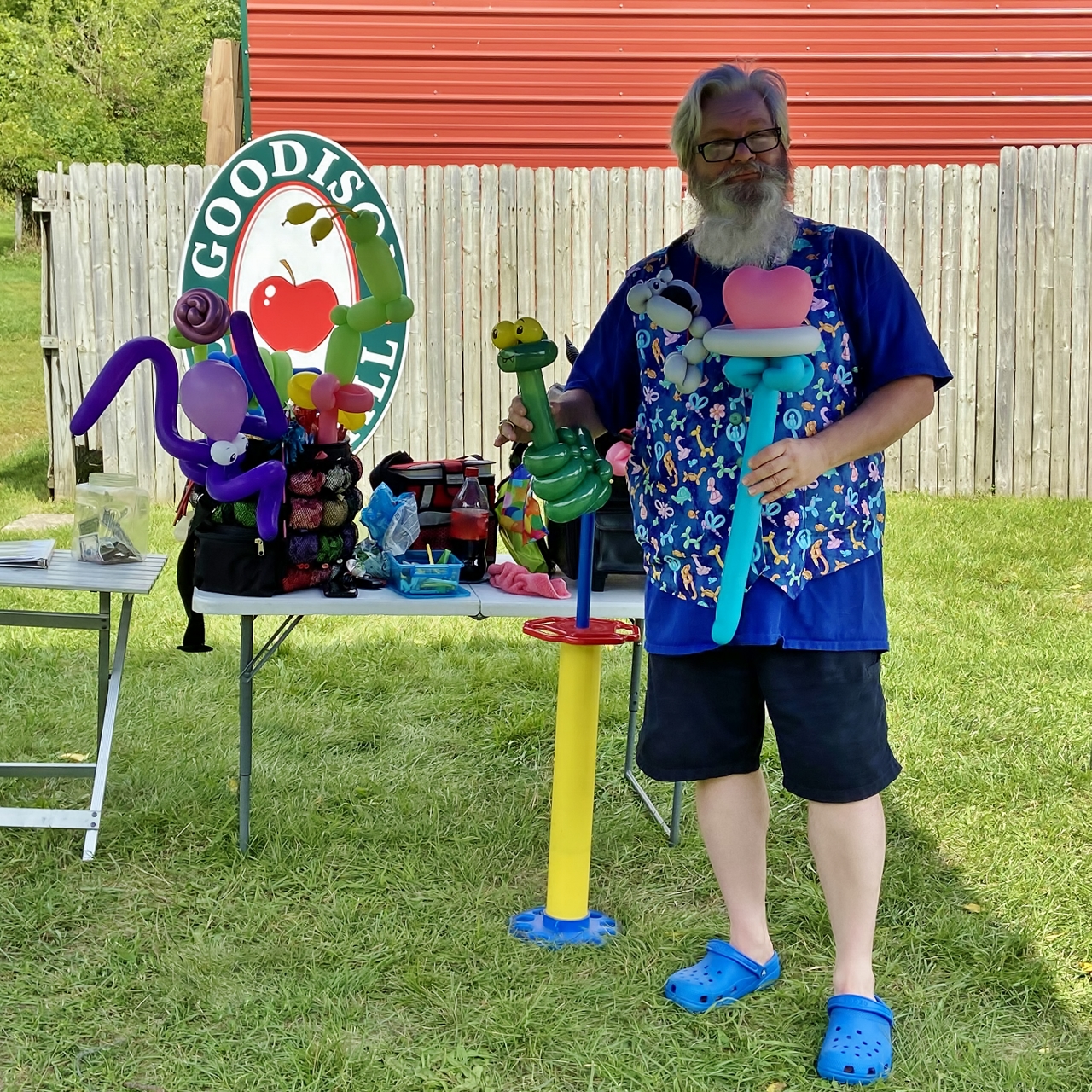 A man holds two twisted balloon creations